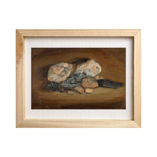 moody still life painting of rocks framed