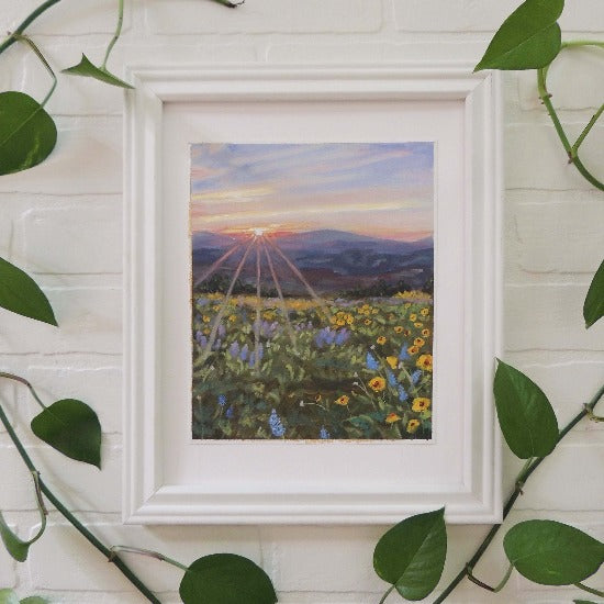 original landscape oil painting  or sunsetting behind mountains with colorful field of flowers in white frame